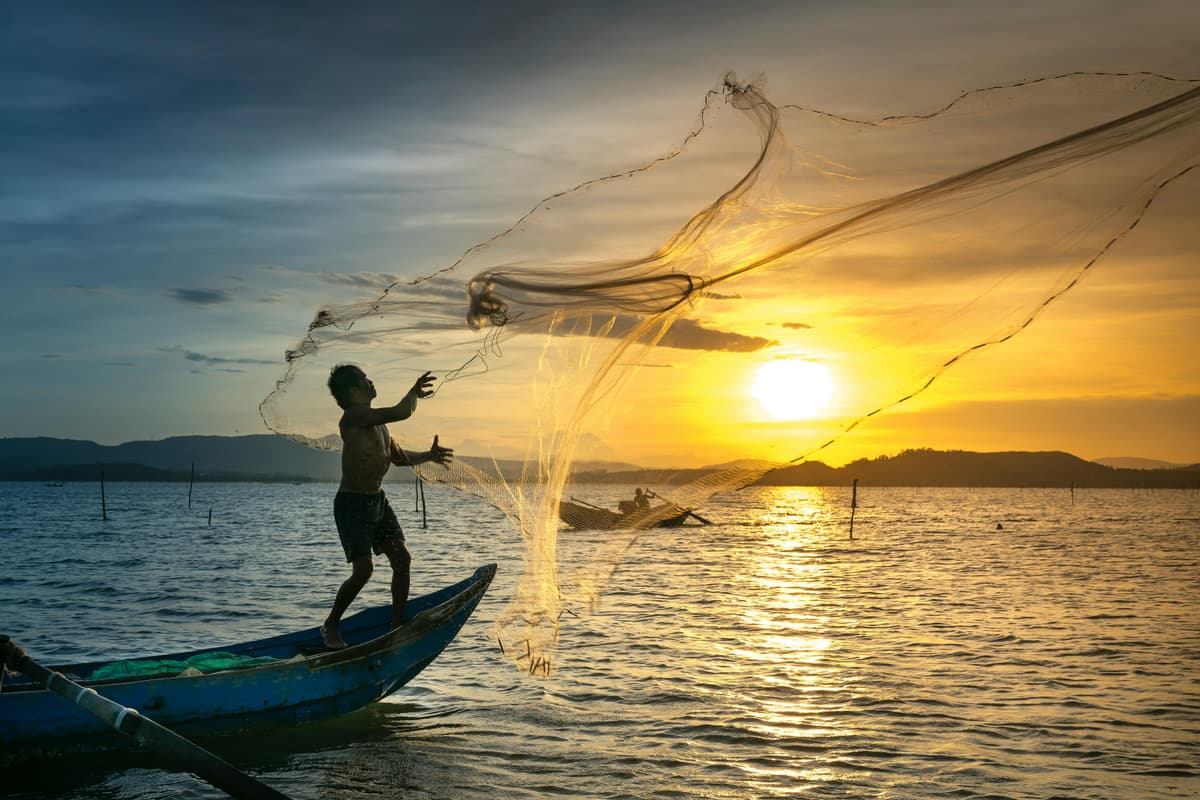 Man fishing at sunset on Mediterranean sea